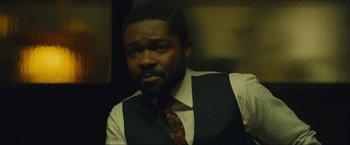 Movie still from “A Most Violent Year” (2014), directed by J.C. Chandor – A man in a vest and tie is looking at the camera; Close Up shot, High angle