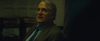 Movie still from “A Most Violent Year” (2014), directed by J.C. Chandor – An older man wearing glasses and a suit; Close Up shot, Over the shoulder angle