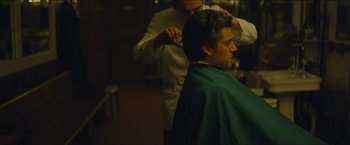 Movie still from “A Most Violent Year” (2014), directed by J.C. Chandor – A man getting his hair cut by a barber; Close Up shot, Over the shoulder angle