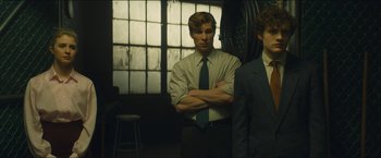 Movie still from “A Most Violent Year” (2014), directed by J.C. Chandor – A man in a suit standing next to another man in a suit; Medium shot, Low angle