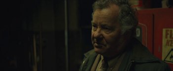 Movie still from “A Most Violent Year” (2014), directed by J.C. Chandor – An older man wearing a suit and a tie; Close Up shot, Over the shoulder angle