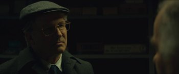 Movie still from “A Most Violent Year” (2014), directed by J.C. Chandor – An older man wearing glasses and a hat; Close Up shot, Over the shoulder angle