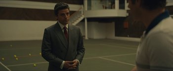 Movie still from “A Most Violent Year” (2014), directed by J.C. Chandor – A man in a suit and tie standing in a court room; Medium shot, Over the shoulder angle