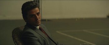 Movie still from “A Most Violent Year” (2014), directed by J.C. Chandor – A man in a suit and tie sitting in a parking lot; Close Up shot, Over the shoulder angle