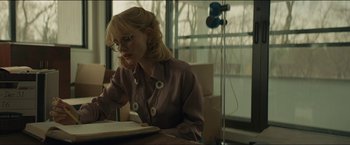 Movie still from “A Most Violent Year” (2014), directed by J.C. Chandor – A woman sitting at a table reading a book; Medium shot, Low angle