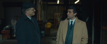 Movie still from “A Most Violent Year” (2014), directed by J.C. Chandor – A man and a woman standing next to each other in a warehouse; Medium shot, Over the shoulder angle