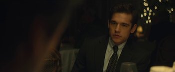 Movie still from “A Most Violent Year” (2014), directed by J.C. Chandor – A man in a suit and tie sitting at a table; Close Up shot, Over the shoulder angle