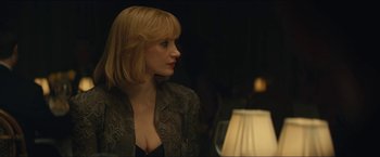 Movie still from “A Most Violent Year” (2014), directed by J.C. Chandor – A woman with blonde hair is looking at a table lamp; Close Up shot, Over the shoulder angle