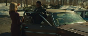 Movie still from “A Most Violent Year” (2014), directed by J.C. Chandor – A man standing in the back seat of a car; Medium shot, Low angle