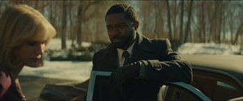 Movie still from “A Most Violent Year” (2014), directed by J.C. Chandor – A man wearing a suit and tie holding a knife; Medium shot, Over the shoulder angle