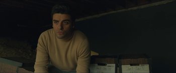 Movie still from “A Most Violent Year” (2014), directed by J.C. Chandor – A man in a tan sweater sitting in a room; Medium shot, Low angle