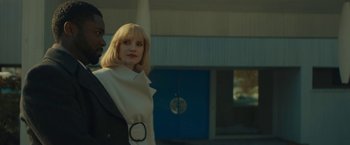Movie still from “A Most Violent Year” (2014), directed by J.C. Chandor – A woman standing next to a man in front of a building; Medium shot, Low angle