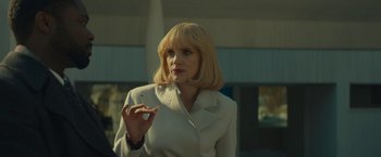 Movie still from “A Most Violent Year” (2014), directed by J.C. Chandor – A woman in a white jacket holding a cigarette; Medium shot, Low angle