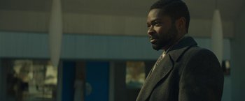 Movie still from “A Most Violent Year” (2014), directed by J.C. Chandor – A man in a suit standing in front of a building; Close Up shot, Low angle