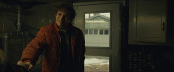 Movie still from “A Most Violent Year” (2014), directed by J.C. Chandor – A young man standing in front of an open door; Medium shot, Over the shoulder angle