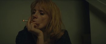 Movie still from “A Most Violent Year” (2014), directed by J.C. Chandor – A woman sitting in front of a wall with her hand on her chin; Close Up shot, Low angle