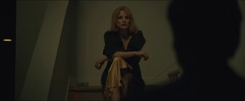 Movie still from “A Most Violent Year” (2014), directed by J.C. Chandor – A woman sitting on the stairs in a dark room; Medium shot, Over the shoulder angle