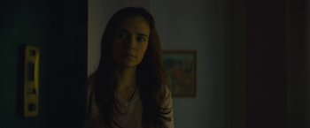 Movie still from “A Most Violent Year” (2014), directed by J.C. Chandor – A woman standing in a room in the dark looking at the camera; Close Up shot, Low angle