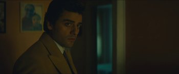 Movie still from “A Most Violent Year” (2014), directed by J.C. Chandor – A man wearing a suit and tie standing in a room; Close Up shot, Over the shoulder angle
