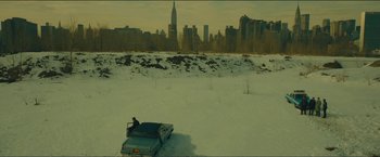 Movie still from “A Most Violent Year” (2014), directed by J.C. Chandor – A man standing next to a truck in the snow; Extreme Wide shot, High angle