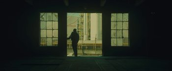 Movie still from “A Most Violent Year” (2014), directed by J.C. Chandor – A man standing in front of an open door; Extreme Wide shot, Low angle