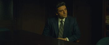 Movie still from “A Most Violent Year” (2014), directed by J.C. Chandor – A man in a suit sitting at a table; Medium shot, Low angle