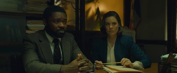 Movie still from “A Most Violent Year” (2014), directed by J.C. Chandor – A man and a woman sitting at a table; Medium shot, Low angle