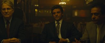 Movie still from “A Most Violent Year” (2014), directed by J.C. Chandor – A man in a suit sitting in front of a table; Medium shot, Low angle