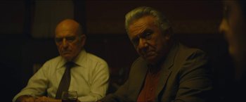 Movie still from “A Most Violent Year” (2014), directed by J.C. Chandor – Two older men sitting at a table in front of each other; Medium shot, Over the shoulder angle