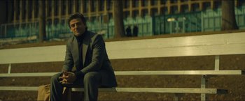 Movie still from “A Most Violent Year” (2014), directed by J.C. Chandor – A man sitting on top of a wooden bench; Medium shot, Low angle