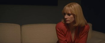 Movie still from “A Most Violent Year” (2014), directed by J.C. Chandor – A woman sitting on a couch in a room; Close Up shot, Over the shoulder angle
