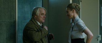 Movie still from “A Most Wanted Man” (2014), directed by Anton Corbijn – A man and a woman standing next to each other; Medium shot, Over the shoulder angle