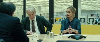 Movie still from “A Most Wanted Man” (2014), directed by Anton Corbijn – A man and a woman sitting at a table; Medium shot, Over the shoulder angle