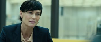 Movie still from “A Most Wanted Man” (2014), directed by Anton Corbijn – A person wearing a suit; Close Up shot, Over the shoulder angle