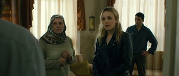 Movie still from “A Most Wanted Man” (2014), directed by Anton Corbijn – Two women standing next to each other in a room; Medium shot, Over the shoulder angle