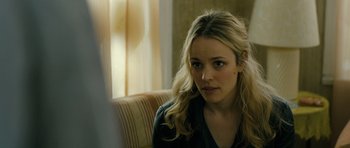 Movie still from “A Most Wanted Man” (2014), directed by Anton Corbijn – A woman sitting on a couch in a living room; Close Up shot, Over the shoulder angle