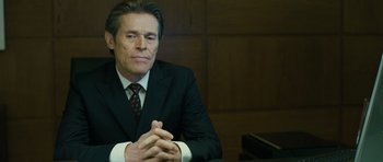 Movie still from “A Most Wanted Man” (2014), directed by Anton Corbijn – A person wearing a suit and tie; Close Up shot, Over the shoulder angle