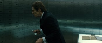 Movie still from “A Most Wanted Man” (2014), directed by Anton Corbijn – A man in a black suit is holding a cell phone in his hand; Close Up shot, Low angle