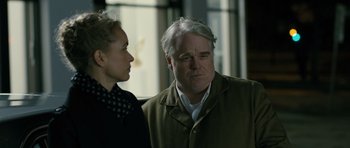 Movie still from “A Most Wanted Man” (2014), directed by Anton Corbijn – A man and a woman standing next to each other in a room; Close Up shot, Over the shoulder angle