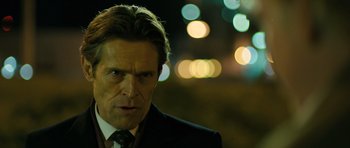 Movie still from “A Most Wanted Man” (2014), directed by Anton Corbijn – A person wearing a suit and tie; Close Up shot, Over the shoulder angle