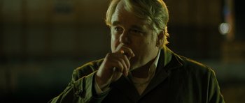 Movie still from “A Most Wanted Man” (2014), directed by Anton Corbijn – A person smoking a cigarette; Close Up shot, Over the shoulder angle