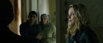 Movie still from “A Most Wanted Man” (2014), directed by Anton Corbijn – A woman in a head scarf standing next to two men; Close Up shot, Over the shoulder angle