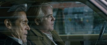 Movie still from “A Most Wanted Man” (2014), directed by Anton Corbijn – A man sitting in a car looking out the window; Close Up shot, Over the shoulder angle