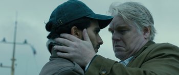 Movie still from “A Most Wanted Man” (2014), directed by Anton Corbijn – A man and a woman embracing each other; Close Up shot, Over the shoulder angle