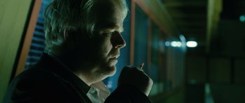 Movie still from “A Most Wanted Man” (2014), directed by Anton Corbijn – A person holding a cigarette in his mouth; Close Up shot, Over the shoulder angle