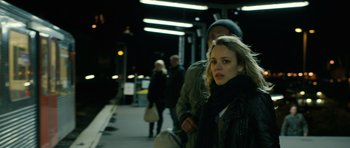 Movie still from “A Most Wanted Man” (2014), directed by Anton Corbijn – A woman standing next to a man on a sidewalk; Medium shot, Over the shoulder angle