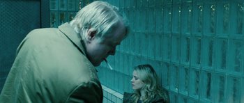 Movie still from “A Most Wanted Man” (2014), directed by Anton Corbijn – A man and a woman standing next to each other in front of tiled walls; Close Up shot, Over the shoulder angle