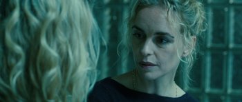 Movie still from “A Most Wanted Man” (2014), directed by Anton Corbijn – A woman looking at her reflection in a mirror; Close Up shot, Over the shoulder angle