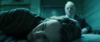 Movie still from “A Most Wanted Man” (2014), directed by Anton Corbijn – A woman's face with a man in the background; Close Up shot, Over the shoulder angle