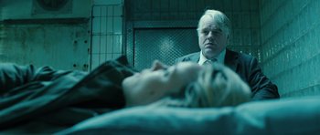 Movie still from “A Most Wanted Man” (2014), directed by Anton Corbijn – A man sitting in front of a woman laying on a bed; Close Up shot, Over the shoulder angle